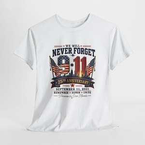 May include: A white short-sleeved t-shirt featuring a graphic print that reads WE WILL NEVER FORGET 9-11 25TH ANNIVERSARY SEPTEMBER 11, 2001 REMEMBER HONOR UNITE Forever in Our Hearts, with American flags, a city skyline, and a small airplane silhouette.