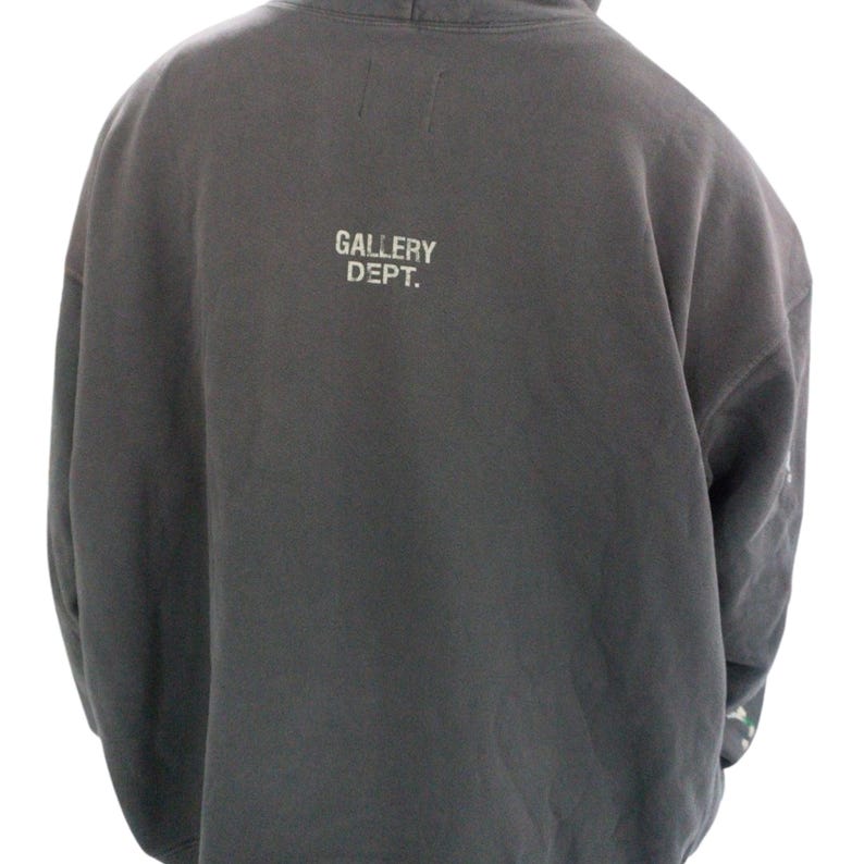 May include: Dark gray hoodie with the text "GALLERY DEPT." printed in white on the back. The hoodie has a hood and long sleeves. The fabric appears to be a soft, comfortable material.