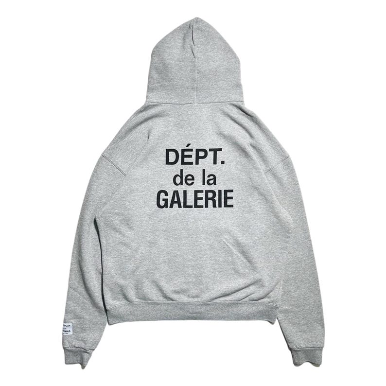 May include: A heather gray hoodie with a drawstring hood. The back of the sweatshirt features the text "D&Eacute;PT. de la GALERIE" in black block letters. The hoodie has a kangaroo pocket and ribbed cuffs and hem.
