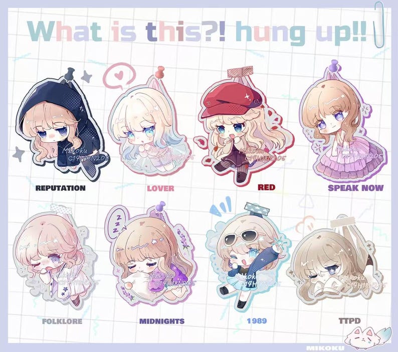 May include: A collection of eight anime-style character charms, each with a unique design and color scheme. The charms feature characters with large eyes and various outfits, with text labels including "REPUTATION," "LOVER," and "RED." The phrase "What is this?! hung up!!" is at the top.