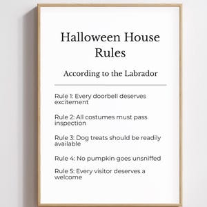 May include: A framed wall print with black text on a white background titled Halloween House Rules According to the Labrador. It lists five rules regarding doorbells, costumes, dog treats, pumpkins, and visitors in a simple font.