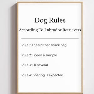 May include: A framed print with the text "Dog Rules According To Labrador Retrievers." The rules are: "I heard that snack bag," "I need a sample," "Or several," and "Sharing is expected." The frame is a light brown color.