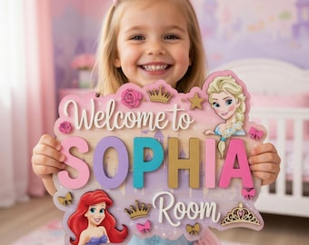 May include: A decorative wooden sign with the text Welcome to SOPHIA Room. The sign features colorful 3D lettering, illustrations of two animated princesses, and small wooden accents including crowns, stars, roses, and bows in pink, gold, and blue.