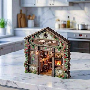 May include: A miniature wooden replica of "The Old Lion Pub," established in 1888. The model features a detailed interior with a bar, stools, and a fireplace. The exterior is adorned with climbing vines, red roses, and stone accents. The pub has two hanging lanterns.