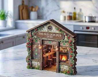 May include: A miniature wooden pub model titled The Old Lion Pub Est. 1888, featuring a detailed interior with a bar, stools, and a fireplace. The exterior is decorated with climbing green vines and red roses, with small lanterns flanking the entrance.