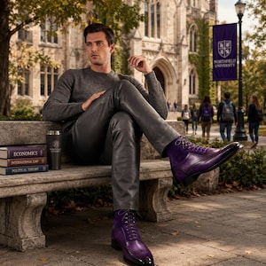May include: A person wearing a gray sweater and leather pants, seated on a stone bench. The person is wearing purple leather boots with intricate detailing. A black tumbler and books with titles like "Economics" are on the bench.