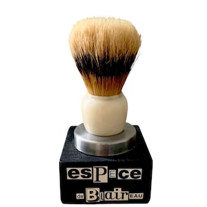 Op de afbeelding: Een set van drie keramische mokken met een gespikkelde, matte afwerking. De mokken zijn in crème, lichtgrijs en donkergrijs. Elke mok heeft een eenvoudig, minimalistisch ontwerp.