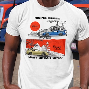 May include: White t-shirt featuring a Japanese-inspired design with two sports cars, a rising sun, and the text "RISING SPEED" and "LIMIT BREAK SPEC". The design includes Japanese text and a pagoda.