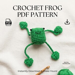 May include: A green crochet frog with black eyes and a smiling mouth, with the text "CROCHET FROG PDF PATTERN". The image also includes a PDF icon, a download icon, and the text "Instantly Download & Make Yours!"