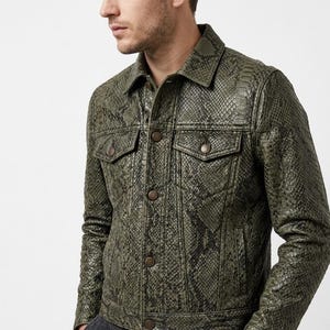 May include: Olive green snakeskin-patterned jacket with a classic collar, two chest pockets, and button closures. The jacket has a textured appearance and a tailored fit, offering a stylish outerwear option.