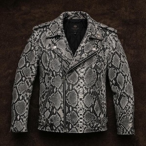 May include: A motorcycle jacket featuring a black and white snakeskin pattern. The jacket includes a notched lapel, an asymmetrical front zipper closure, two zippered side pockets, shoulder epaulets, and a buckled belt at the waist hem.