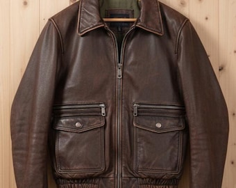 Handgjord, sliten, brun flygjacka i läder – vintagepilotstil