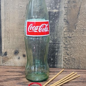 May include: A set of three ceramic nesting bowls in graduating sizes. The bowls are white with a speckled, textured finish and feature a slightly flared rim. The largest bowl measures approximately 8 inches in diameter.