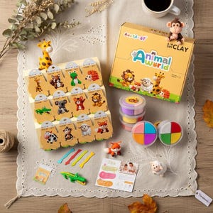 May include: A collection of air-dry clay animal figurines and modeling clay. The set includes a box labeled "Animal World" with various animal figures, colorful clay containers, and animal-shaped clay models. The color palette includes yellow, orange, green, and brown.