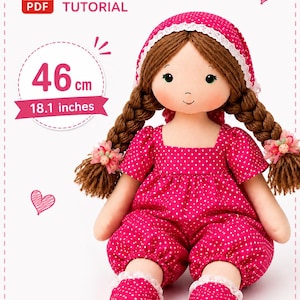 May include: A fabric doll with brown yarn hair in two braids, wearing a pink polka-dot outfit with a matching bonnet and shoes. The doll measures 18.1 inches in height. The image includes a PDF tutorial icon and text indicating 46 cm and 18.1 inches.