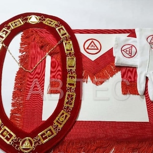 May include: A set of Masonic regalia, including a red velvet collar with gold-colored links, a red and white apron, and white gloves. The apron and gloves feature a red emblem. The set is likely used for ceremonial purposes.