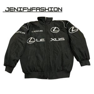 May include: Black zip-up jacket featuring white "LEXUS" lettering and logo. The jacket has a stand-up collar, white piping, and ribbed cuffs and hem. The text "JENIFYFASHION" is above the jacket.