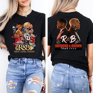 May include: Black t-shirt featuring a collage of R&B artists with the text "R&B Next Level Vision" on the front. The back of the shirt displays two figures and the text "R&B Raymond & Brown Tour 2026".