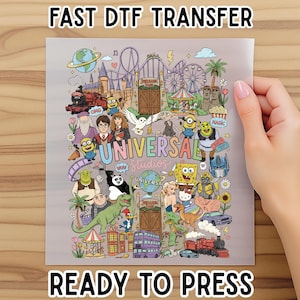 May include: A rectangular DTF transfer sheet featuring a colorful collage of various cartoon characters, movie icons, and theme park attractions. The text "UNIVERSAL STUDIOS" is centered in the middle, surrounded by illustrations of trains, dinosaurs, and famous figures.