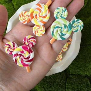 May include: A set of three ceramic mugs with a speckled, matte finish. The mugs are in shades of cream, light gray, and dark gray. Each mug has a simple, minimalist design, perfect for coffee or tea.