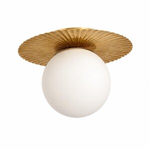May include: A flush mount ceiling light fixture featuring a large, spherical white glass globe attached to a circular, metallic gold-toned base with a textured, pleated, or fluted fan-like design radiating from the center point of the fixture.