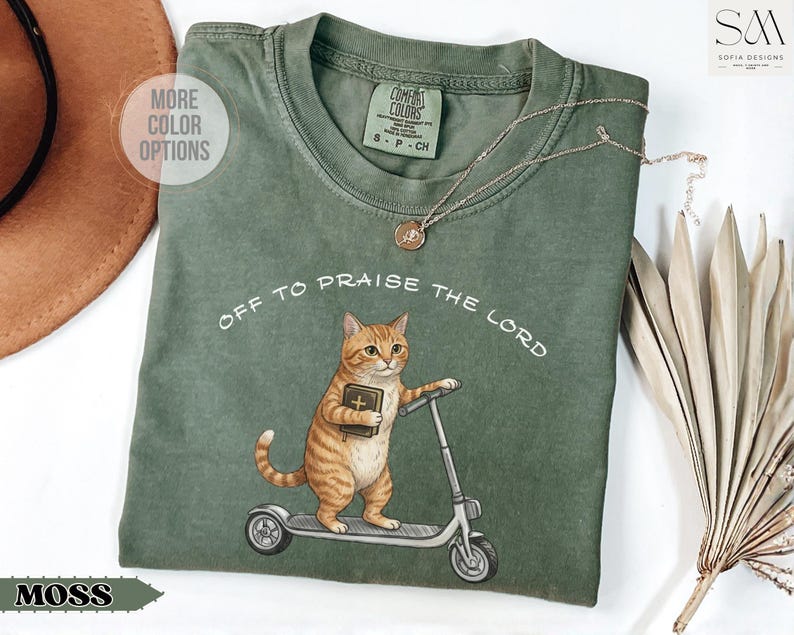 Funny Christian cat shirt with orange tabby riding scooter and holding Bible, Off To Praise The Lord graphic tee, cute religious cat lover gift shirt