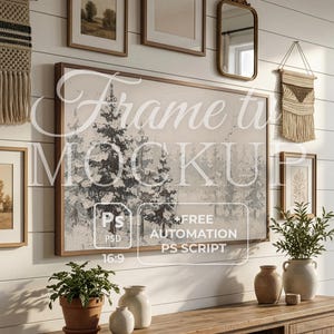 May include: A wall-mounted display featuring framed artwork, a mirror, and decorative macrame hangings. The artwork includes a landscape painting and a large framed print with a winter scene. A wooden cabinet holds vases and potted plants, creating a cozy, rustic aesthetic.