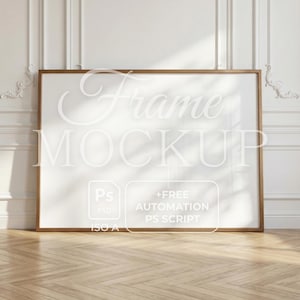 May include: A rectangular frame mockup with a gold-colored frame, leaning against a white wall with decorative molding. The frame contains the text "Frame MOCKUP" and a graphic with the text "+FREE AUTOMATION PS SCRIPT". The floor is made of light-colored wood.