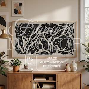 May include: A wooden media console with a large framed artwork featuring a black and white abstract floral design. The artwork is above the console, which has a mid-century modern style. The console has a variety of decorative items.