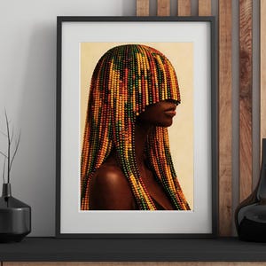 K&ouml;nnte beinhalten: Gerahmter Kunstdruck mit dem Profil einer Person mit dunkler Haut und Perlenhaar. Das Haar besteht aus farbigen Perlen in Gelb-, Orange-, Rot- und Gr&uuml;nt&ouml;nen. Das Kunstwerk wird in einem schwarzen Rahmen pr&auml;sentiert.