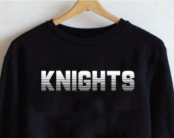 May include: Black sweatshirt with white text that reads "KNIGHTS" in a retro, striped font.