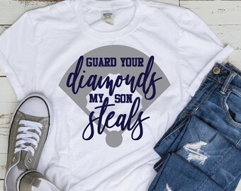 May include: White t-shirt with a gray baseball diamond graphic and the text "GUARD YOUR diamonds MY SON steals" in navy blue.