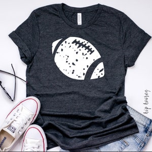 May include: A dark gray t-shirt with a white distressed football graphic. The shirt is made of a soft, comfortable material.
