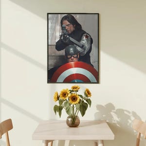 May include: A framed print featuring two characters from a superhero movie. One is aiming a gun, the other is behind a shield. A vase of sunflowers sits on a light-colored table, with two chairs on either side.