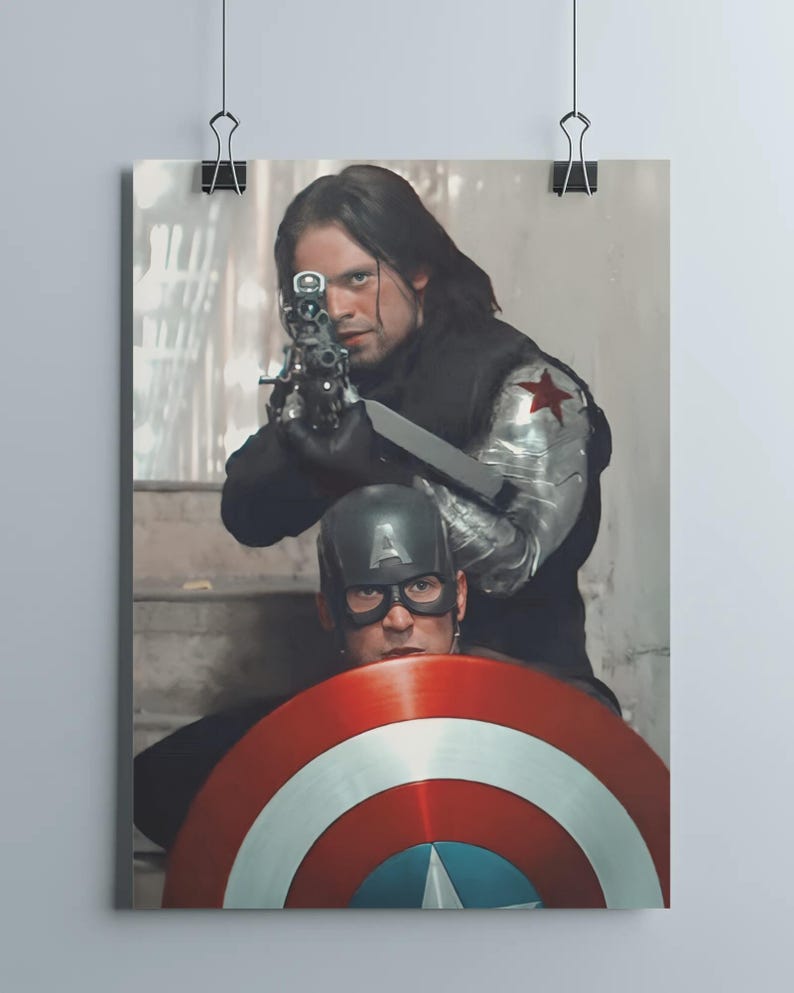 May include: A poster featuring two characters from a movie. One character is aiming a gun, wearing a black outfit with a metal arm and a red star. The other character is wearing a helmet and holding a shield with red, white, and blue stripes.