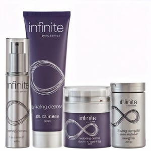 May include: A collection of skincare products with the brand name "infinite" in silver and purple packaging. The set includes a serum, cleanser, cooling creme, and a finishing complex. Each product features a stylized infinity symbol.