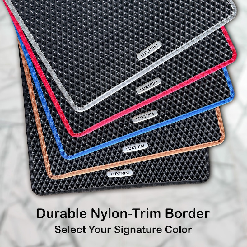 May include: A stack of black mats with nylon trim in silver, red, blue, and bronze. Each mat has a textured surface and a small label that reads "LUXTRIM". The text at the bottom says "Durable Nylon-Trim Border. Select Your Signature Colour."