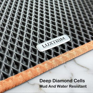 May include: A close-up of a grey car floor mat with a diamond pattern. The mat features a silver "LUXTRIM" emblem and a copper-coloured border. Text at the bottom reads "Deep Diamond Cells Mud And Water Resistant."