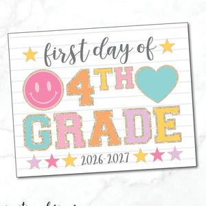 May include: A rectangular sign with a white lined paper background featuring the text first day of 4TH GRADE 2026-2027. The design includes a pink smiley face, a teal heart, and colorful glitter-style letters in orange, yellow, pink, and teal.