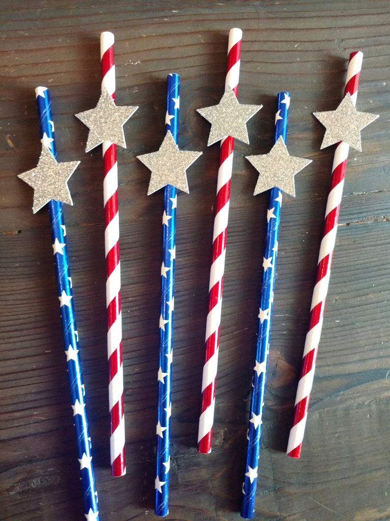 May include: Six red, white, and blue striped paper straws with silver glitter stars attached to the top.