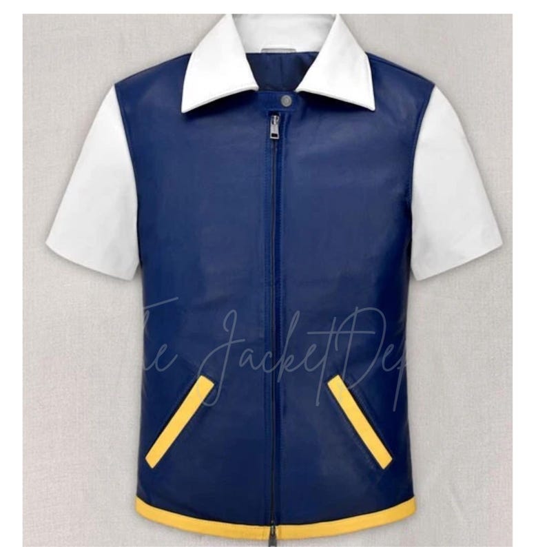 May include: A blue and white short-sleeved jacket with a white collar and a full-length zipper. The jacket has yellow accents on the pockets and bottom hem. The Jacket Dept. is written on the bottom of the jacket.
