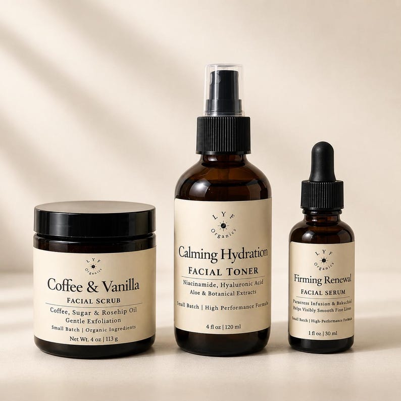 May include: Three amber glass skincare containers with cream labels. A 4 oz jar of Coffee & Vanilla Facial Scrub, a 4 fl oz spray bottle of Calming Hydration Facial Toner with Niacinamide, and a 1 fl oz dropper bottle of Firming Renewal Facial Serum.