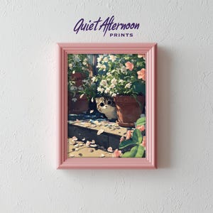 May include: A framed print depicting a cat amongst potted plants, with a soft, pastel colour scheme. The artwork features pink and white flowers. The frame is a pale pink, and the text "Quiet Afternoon PRINTS" is at the top.