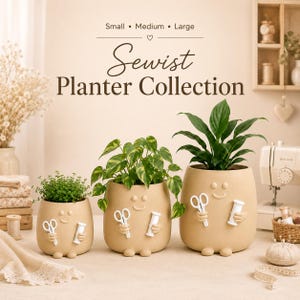 May include: Three beige ceramic planters in small, medium, and large sizes, each featuring a smiling face and sculpted hands holding white scissors and a spool of thread. The text "Sewist Planter Collection" is printed above the planters.