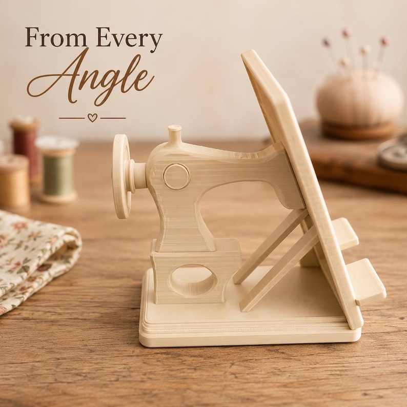 May include: A light-colored wooden stand shaped like a vintage sewing machine with a flat angled support for holding items. The text "From Every Angle" is visible in the upper left corner above the wooden sewing machine structure.