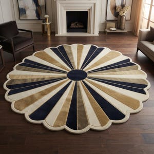 May include: A large, round, scalloped-edge area rug featuring a sunburst pattern. The design consists of alternating wedge-shaped segments in navy blue, tan, and cream, radiating from a solid navy blue circular center point to the outer edge.