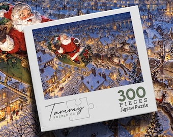 May include: A 300-piece jigsaw puzzle by Tammy Puzzle Co. featuring a festive illustration of Santa Claus in a sleigh pulled by reindeer flying over a snow-covered village at night. The box displays the brand name and piece count clearly.