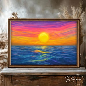 May include: A framed art print depicting a vibrant sunset over the ocean. The artwork features a large yellow sun, orange and pink sky, and blue water. The frame is made of wood. The text "This & That Co. Renees" is in the bottom right corner.