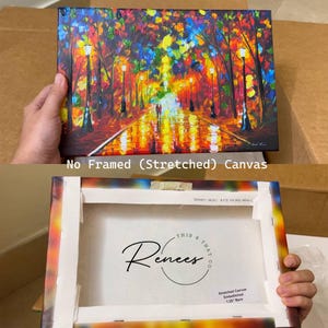 May include: A stretched canvas art print depicting a vibrant, colorful street scene with streetlights and figures. The canvas is labeled "No Framed (Stretched) Canvas." The back of the canvas shows the "THIS & THAT Renees" logo and text that reads "Stretched Canvas Embellished 1.25 Bars."