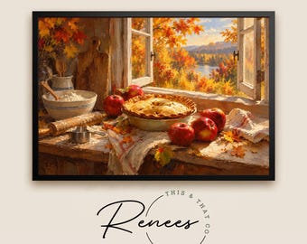 May include: A framed wall art print depicting a rustic kitchen scene with a baked apple pie, fresh red apples, a wooden rolling pin, a mixing bowl with flour, and a cutting board set against an open window view of autumn trees and a lake.